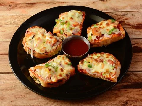 Cheese garlic bread, served over a rustic wooden background, selective focus Stock Photos