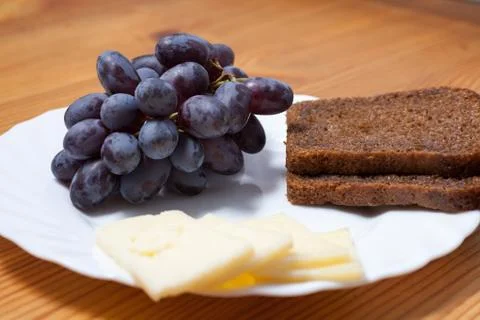 Cheese, grapes and bread Stock-Fotos