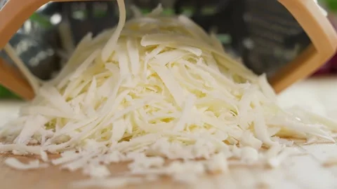 The cheese is grated on a coarse grater. Close-up, macro, front view Stock Footage 266317835