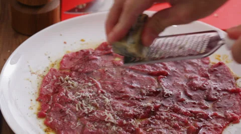 Cheese grating - parmesan cheese at beef carpaccio Stock Footage 35992593