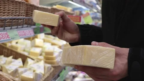Cheese in the hands of a cutomer in a store. Stock Footage 220034586