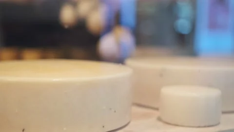 Cheese head round closeup. Dairy production farm interior. Hard goat cheeses Stock Footage 202570283