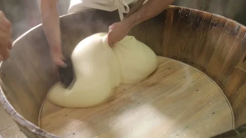 The cheese maker crushes hot cheese with his bare hands. Cooking Suluguni. Stock Footage 116619253