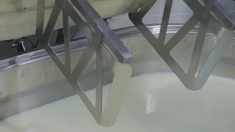 The cheese maker inserts large beaters into a special industrial mixer, lowers Video stock 147907588