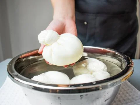 Cheese maker making mozzarella or buratta Stock Photos