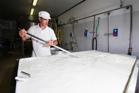 Cheese maker is mixing the milk Stock Photos