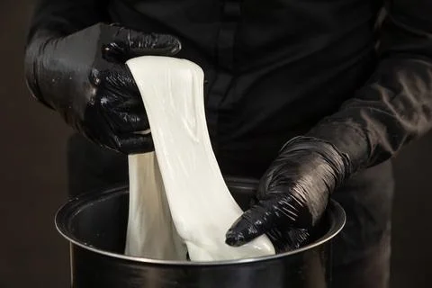Cheese maker preparing mozzarella cheese Stock Photos