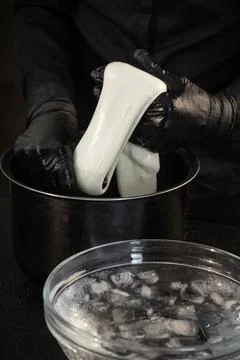 Cheese maker preparing mozzarella cheese Stock Photos
