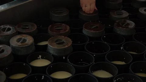 Cheese making process. Chees puts weights on cheese. Stock Footage 119772309