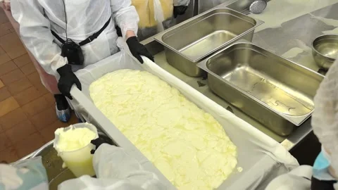 Cheese making process in a workshop with participants wearing protective gear an Stock Footage 325728224