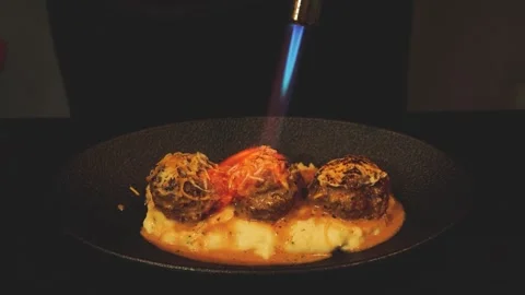 Cheese Melting on Meatballs with Kitchen Torch Close Up Stock Footage 335732734