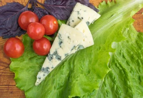 Cheese with Mold with Tomatoes Stock Photos