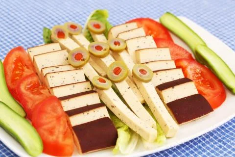 Cheese, olives and vegetables Stock Photos