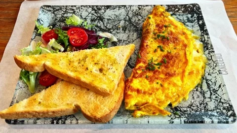Cheese Omelette with Toast and Side Salad Closeup Lunch Plate Stock Footage 329027079