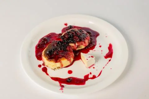Cheese pancake with jam on white background Stock Photos