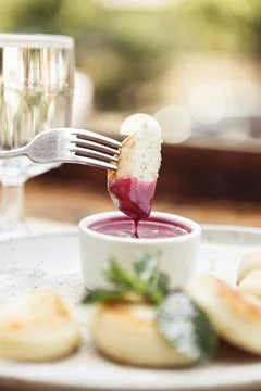 Cheese pancakes with jam. on a light background with glass of water Photos