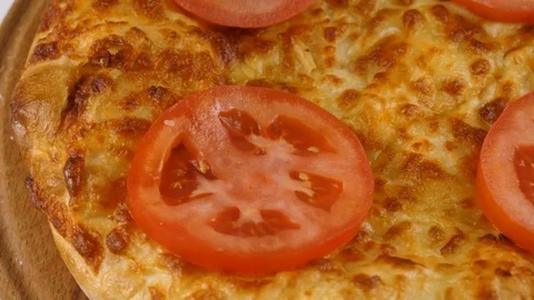 Cheese pie or Khachapuri with sliced tomatoes on top, crispy crust Stock Footage 83159992