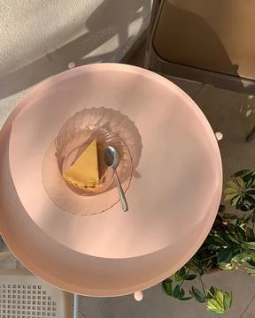 Cheese pie on a pink table, ready to enjoy dessert with ground biscuit base 스톡 사진