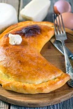 Cheese pie with a slice of butter. Stock Photos