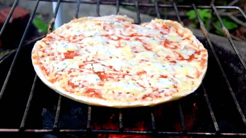 Cheese pizza is cooked on an open fire Stock Footage 159292885