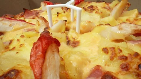 A cheese pizza with pineapple, and crab sticks in macro video. 4K. Stock Footage 263700569