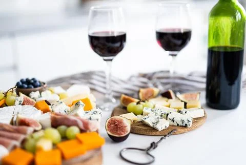 Cheese Plate Appetizer With Bottle Of Red Wine Фото