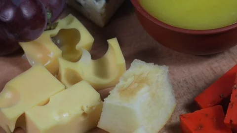 Cheese plate close-up with several varieties of fruit and honey cheese. Stock Footage 107007747