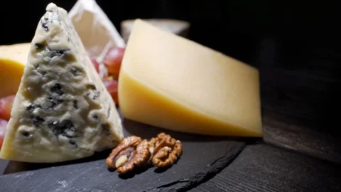 Cheese plate close-up with several varieties of fruit and cheese Stock Footage 123208103