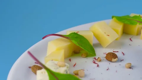 Cheese plate with different kinds of cheese and fresh grape, honey, nuts Stock Footage 78897425