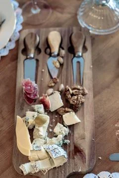 Cheese plate with different types, with walnuts and tasting devices, top view Stock Photos
