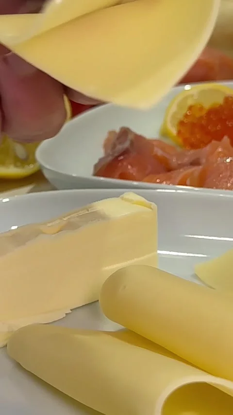 Cheese on a plate Hands spread mayonnaise on bread butter. We take the sprats Stock Footage 327293756