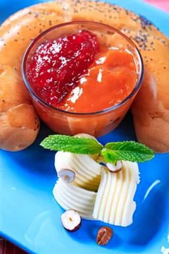 Cheese plate with jam and nuts on blue dish Stock Photos
