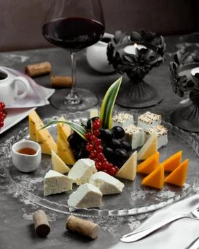 Cheese plate with red wine __ Stock Photos