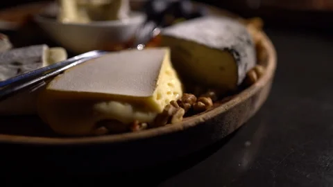 Cheese plate - various types of cheese, grapes, dried apricots, nuts on a w.. Stock Footage 294979120