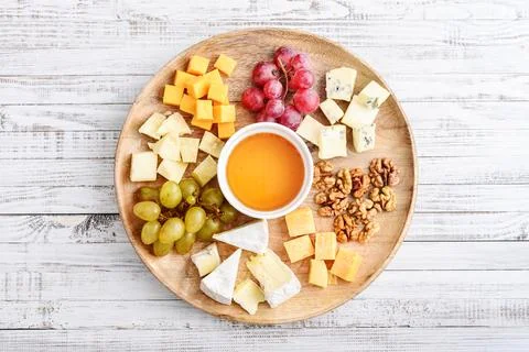 Cheese plate - various types of cheeses with honey Stock Photos