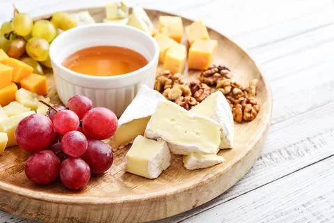 Cheese plate - various types of cheeses with honey Stock Photos