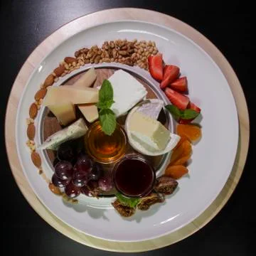 Cheese plate.Isolated on a black background. Stock Photos