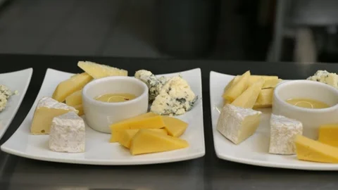 Cheese plates with honey before serving. cheese platter. Diet breakfast concept Stock Footage 309306028