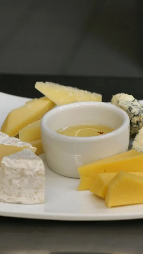 Cheese plates with honey before serving. cheese platter. Diet breakfast concept Stock Footage 309306211