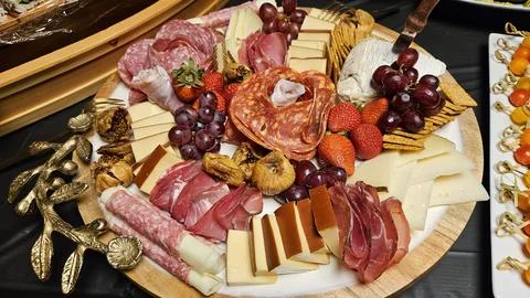 Cheese platter and bite size foods including sushi bar Stock Photos