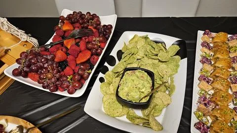 Cheese platter and bite size foods including sushi bar Stock Photos
