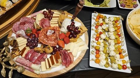 Cheese platter and bite size foods including sushi bar Stock Photos
