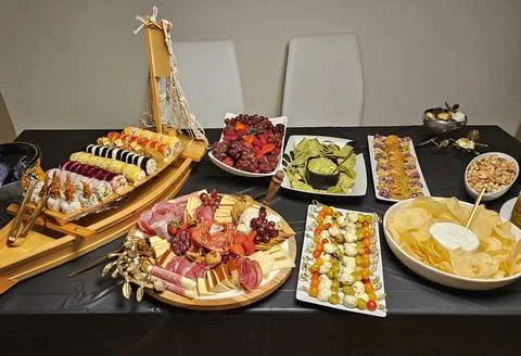 Cheese platter and bite size foods including sushi bar Stock Photos