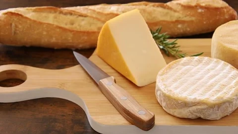 Cheese platter with a baguette on a table Stock Footage 194439134