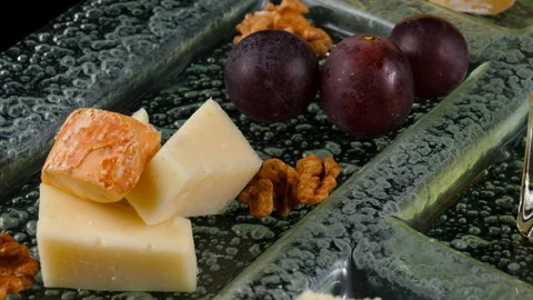 Cheese platter, close-up view, fresh grapes, honey and nuts Stock Footage 90658054