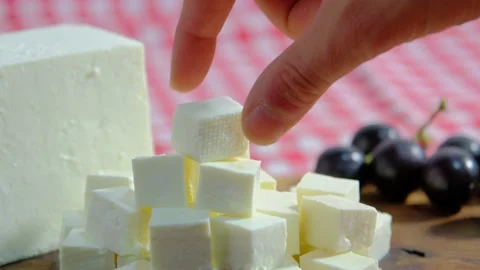 Cheese platter, Cubes of cheese, get cheese from plate. 4K UHD Video Stock Footage 220099540