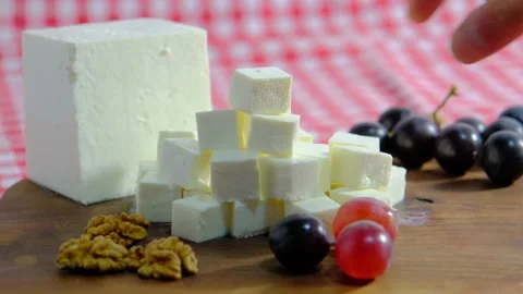 Cheese platter, Cubes of cheese, get cheese from plate. 4K UHD Video Stock Footage 220099578