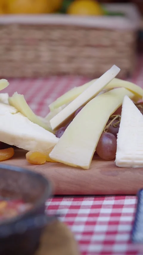Cheese platter display featuring various types of cheese Stock Footage 312540800