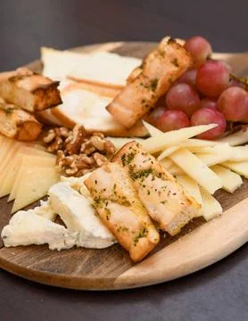 Cheese Platter with Grapes, Walnuts, and Toasted Bread Stock Photos
