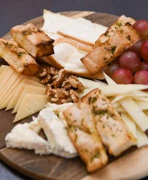 Cheese Platter with Grapes, Walnuts, and Toasted Bread Stock Photos
